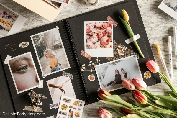 black scrapbook with photos flowers, stickers