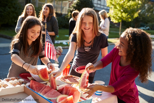 kids enjoying watermelons at a block party