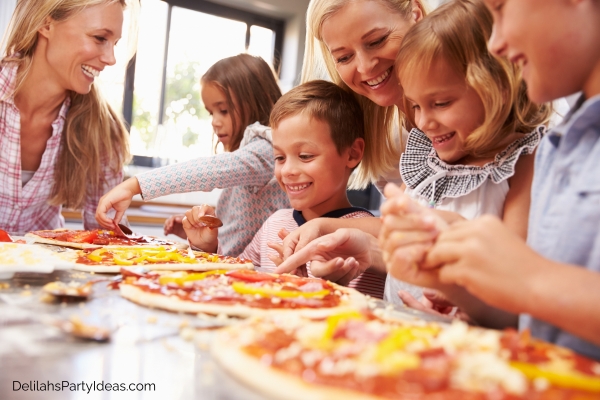 kids in a pizza-making party with their moms
