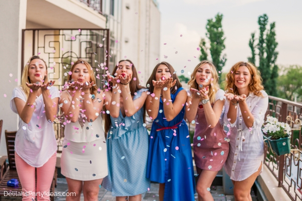 women blowing petals for a bachelorette party