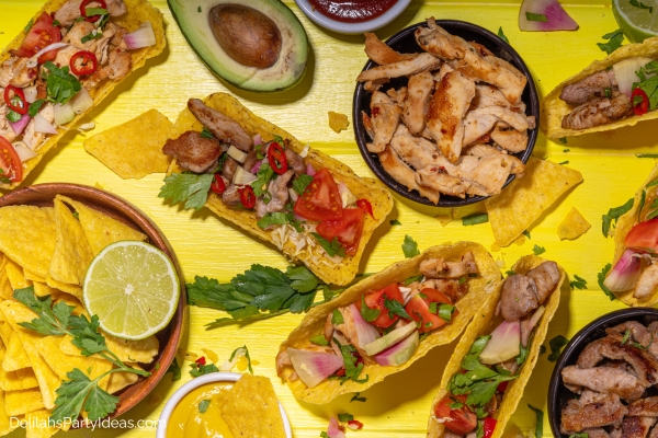 spread of tacos, nachos, meats, avocado, salsa