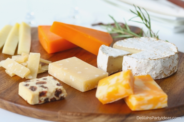 various artisan cheese on wooden board