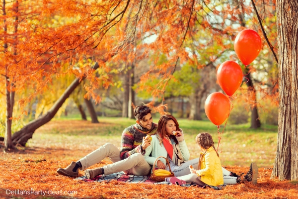 family having a picnic in the park during fall season
