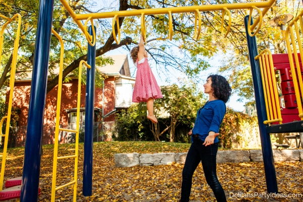 mother and child playing on the playground in fall season